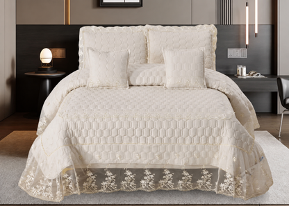 Quilted bedspread with lace trim on a bed in a bedroom setting